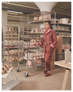woman, possibly a designer, posing with west elm items