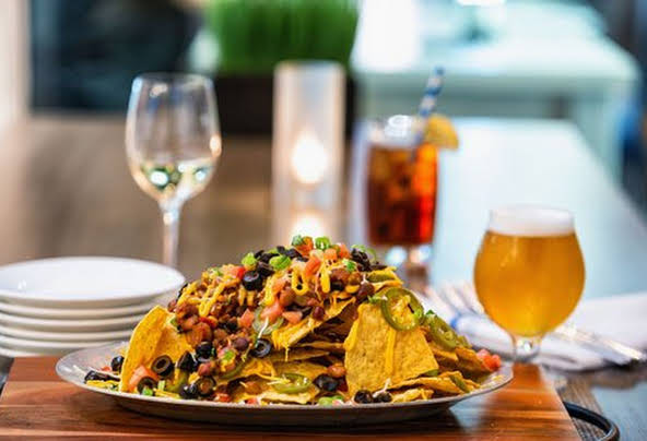 Picture of stacked nachos and an ice cold beer at the Element by Westin Harrison in Newark, NJ