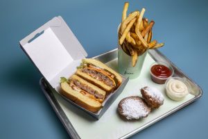 burger and fries meal on a tray at Diesel and Duke